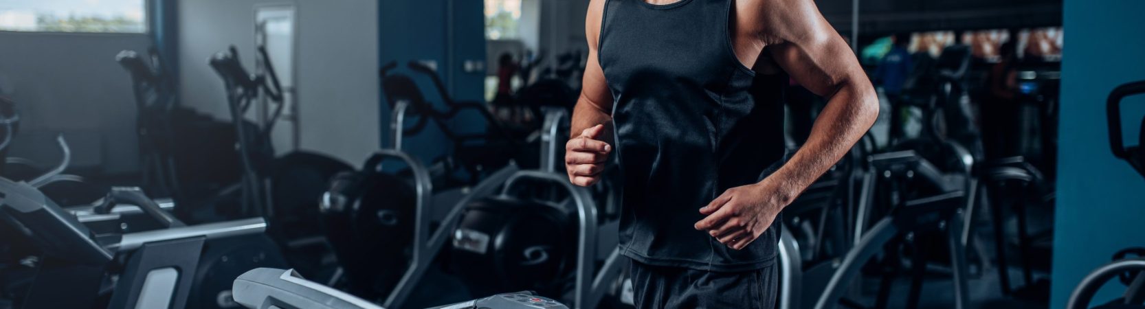 Male athlete workout on running exercise machine Male athlete workout on running exercise machine. Active sport training in gym